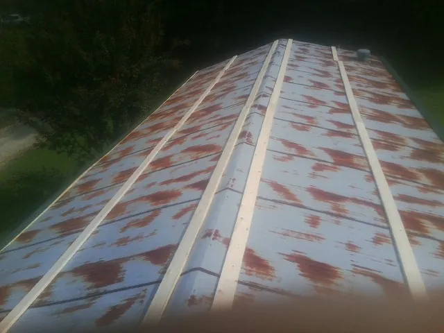 Rusted metal roof panels with new wood purlins before replacement — Storm Damage Roof Repair in Calabasas by Roofing Brothers
